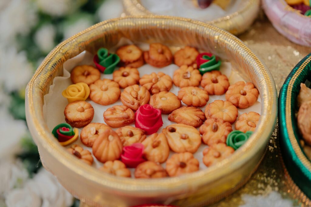 Traditional Indian sweets and colorful decorations arranged in an ornamental festival platter