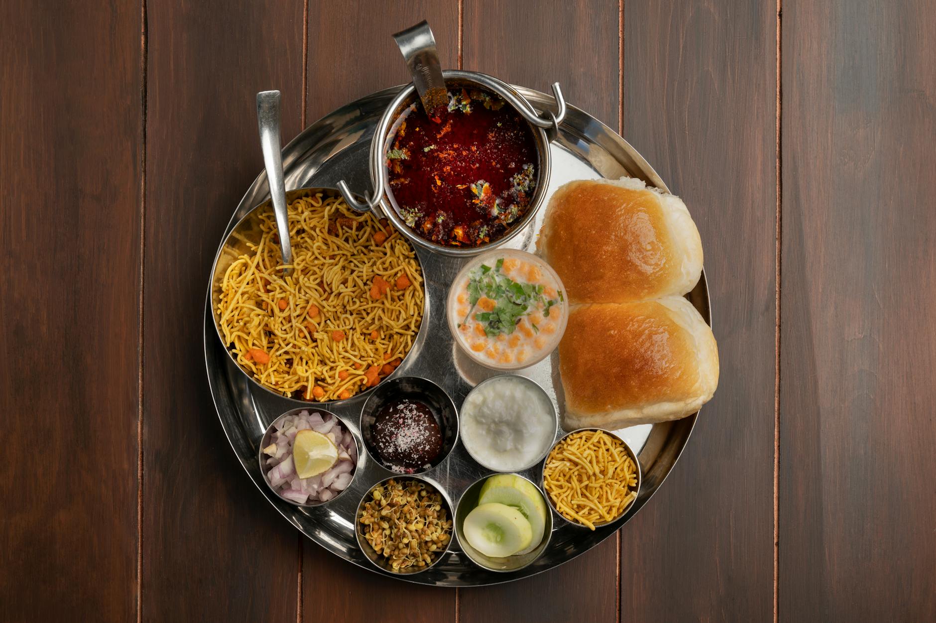 Traditional Maharashtra thali with pav bhaji and Indian dishes