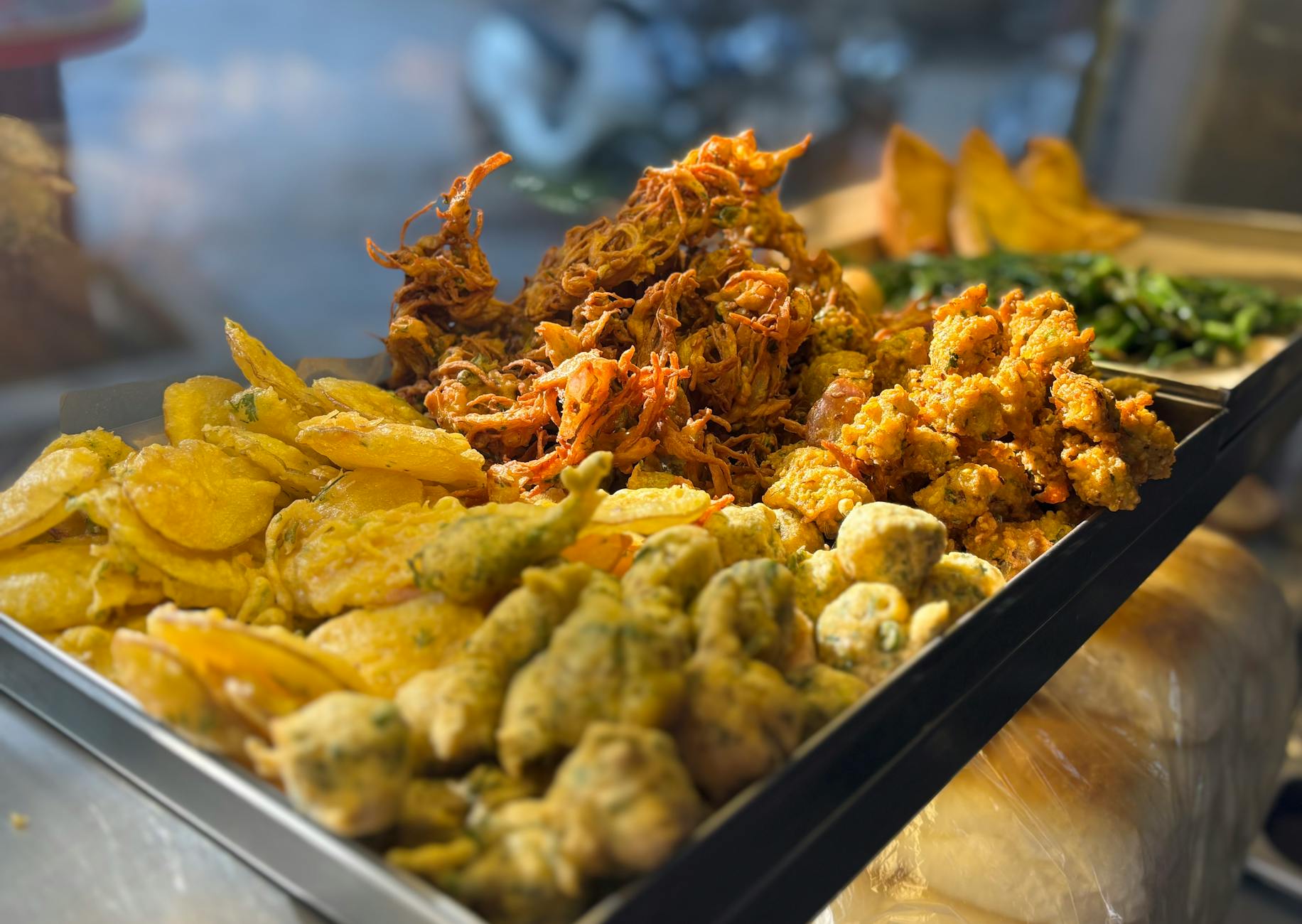 Mumbai street food vendor displaying assorted Indian snacks