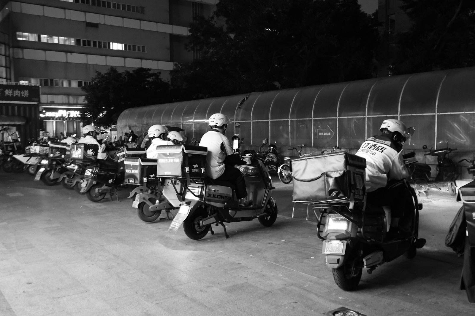 Food delivery riders on scooters collecting cloud kitchen orders in an Indian city