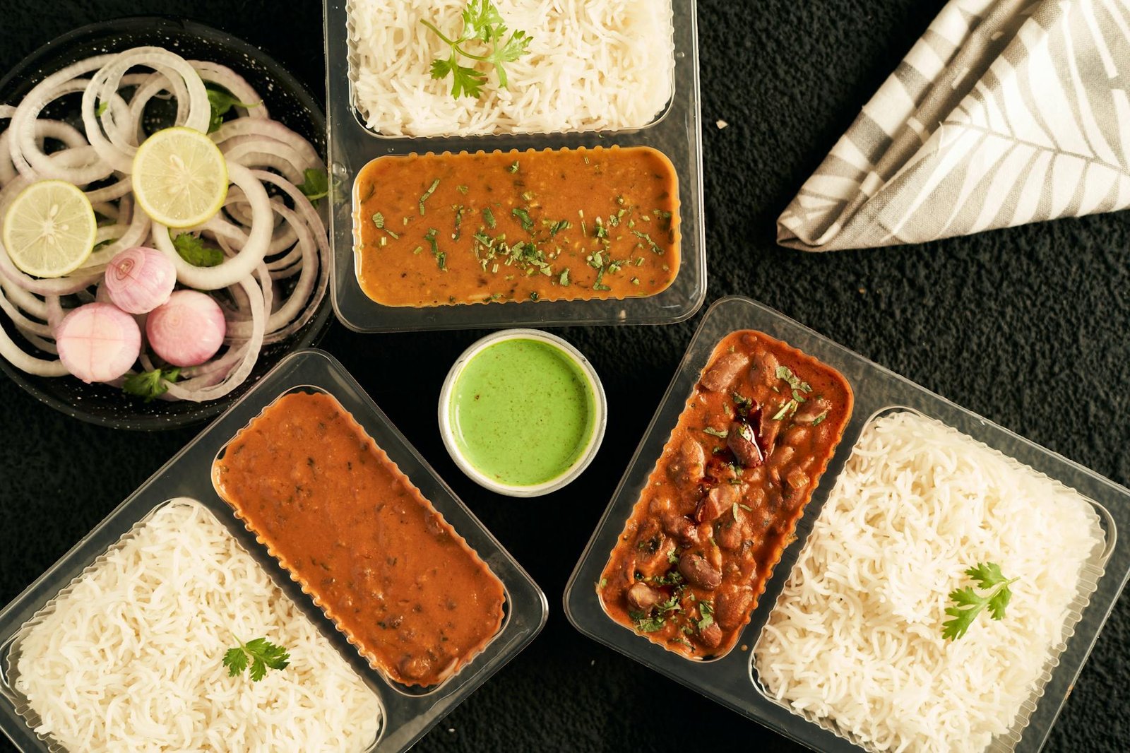 Indian curry and rice packed in takeaway containers for cloud kitchen delivery