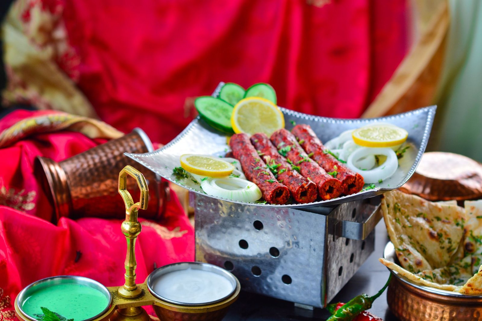 Platter of Indian seekh kebabs with naan and chutney, a popular Eid al-Adha catering dish