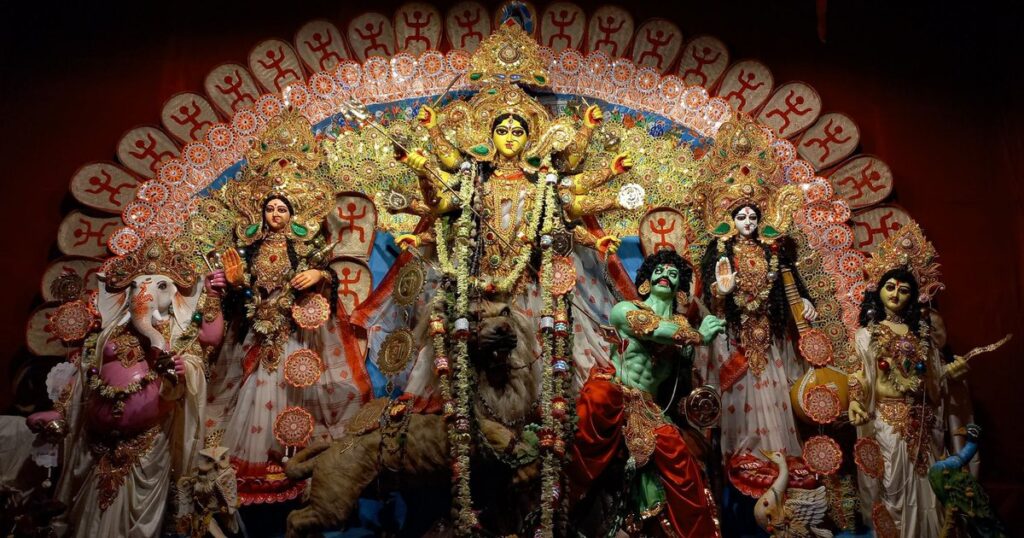 Ornately decorated Durga Puja idol tableau with Goddess Durga on her lion flanked by Lakshmi, Saraswati, Ganesh and Kartikeya