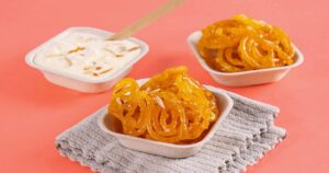 Jalebi and rabri served in CHUK 4-inch compostable bagasse donas with a wooden spoon, festival mithai ready for takeaway
