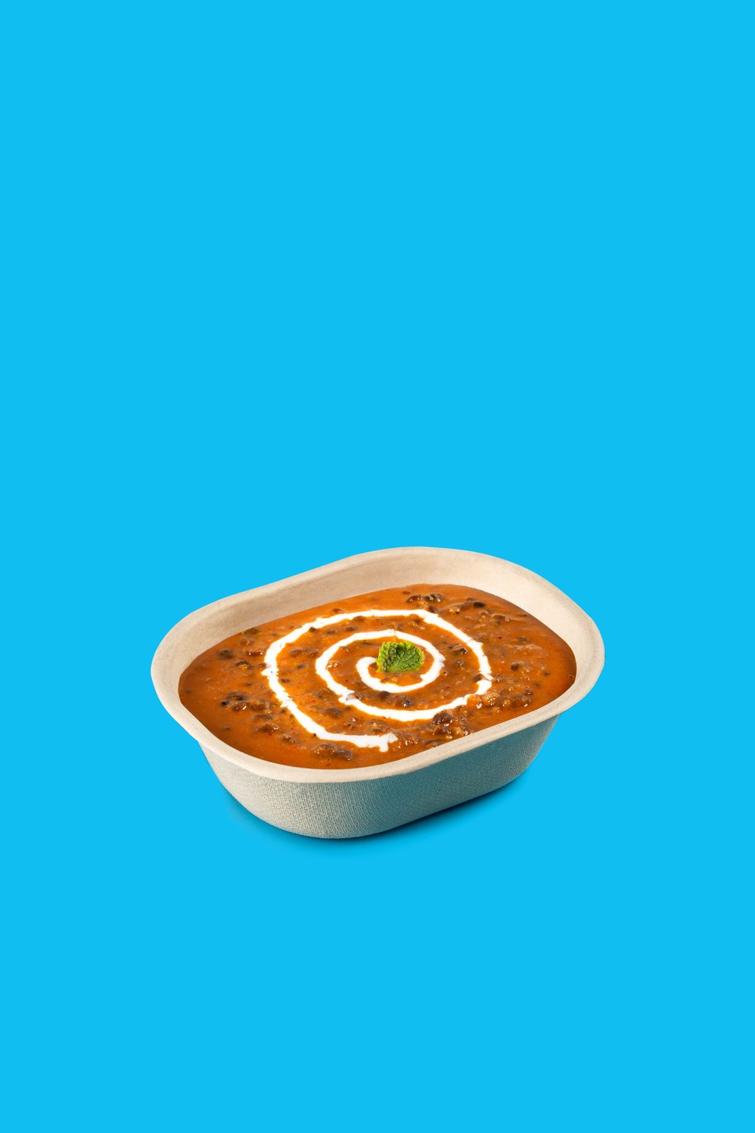 Dal makhani in a CHUK compostable bagasse container, a plastic-free delivery option